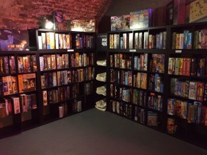 a two walls of bookshelves filled with boardgames